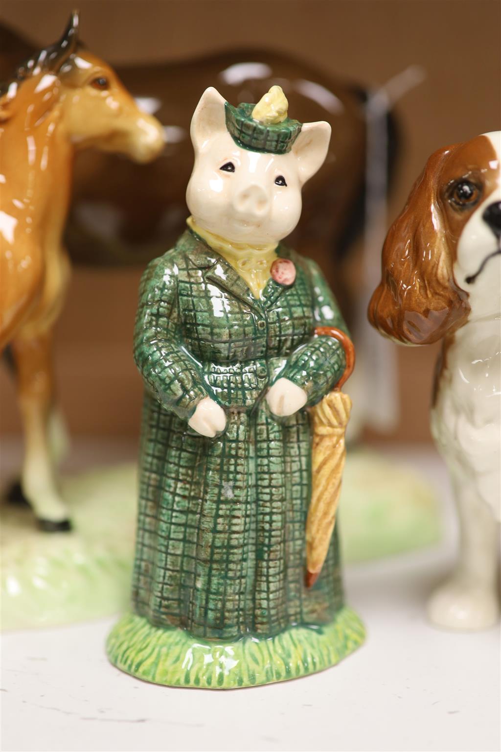 Four Beswick figures: The Lady Pig, King Charles Spaniel, a Doberman, and a horse and foal group, tallest 19cm